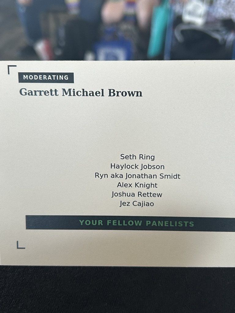 Panel card reading Moderating: Garrett Michael Brown, with the list of fellow panelists